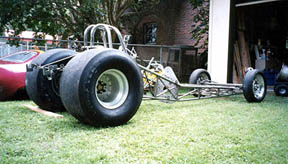 Heres the chassis! I was excited to see these pix back in October at Bakersfield. I was looking for something and this fell in my lap but I was second in line to get it. The pix were there to show Pat Foster and Don Trasin (owner of the Jade Grenade restoration PF had just completed) who are in search of a Sart chassis to go under Tom McEwens Coors (silver) Corvette body. PF said it wasnt right for their project but OKd it as perfect for mine. I dont know fersure the heritage. It was owned at that moment by Mac Burris in Troutman, NC. We came to a financial agreement, and he delivered it to my friend Bob Gilbertsons shop in Charlotte.