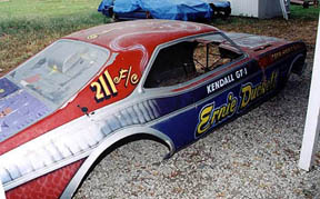 The right side of the plastic shell shows the mostly blue paint design and the name "Ernie Duckett." I personally know little about the man except that he is/was from Alabama, he ran fuel cars for awhile, and later drove alky cars for others. Note that the wheel wells were radiused long ago, a typical necessity when larger tires were mounted on early (wide) chassis. I'll have to fix those back to a more stock configuration.